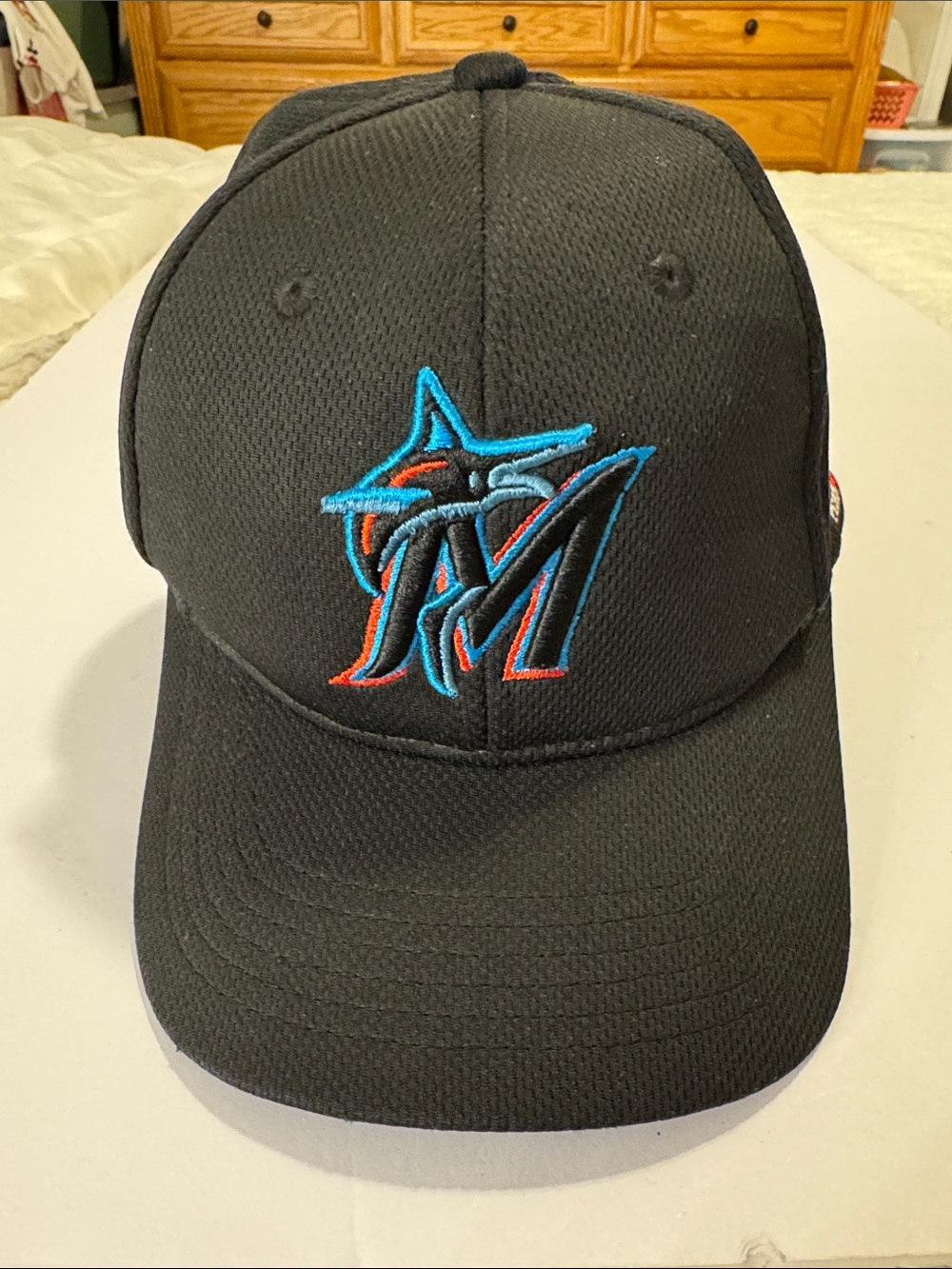 Official Black Baseball Cap with Teal and Orange Logo